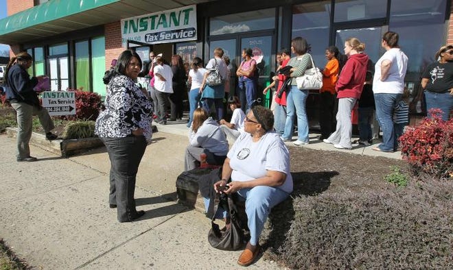 People wait in line at Instant Tax Service on Franklin Boulevard in Gastonia for their IRS tax refunds in January. Many complained at the time the tax preparer had filed returns without permission. Police were dispatched to the office to deal with crowds.
