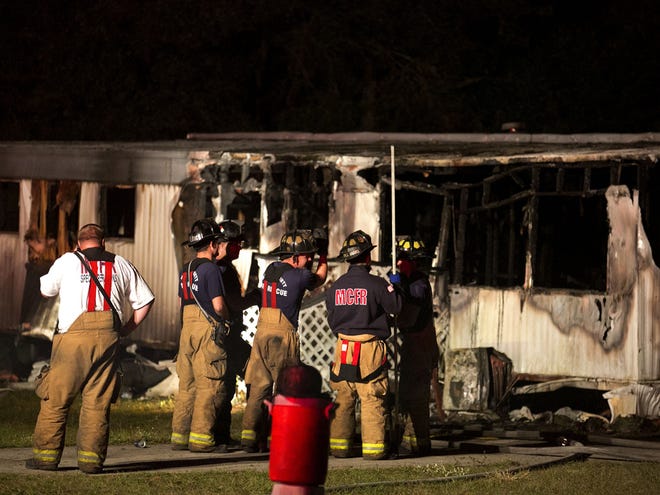 On early Tuesday morning, Marion County Fire Rescue firefighters stand by at an Anthony mobile home that was devastated by fire overnight. One person inside was killed.