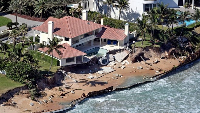 Erosion damages a home and a toppled sea wall caused by Hurricane Sandy in Manalapan on Tuesday. (Gary Coronado/The Palm Beach Post)