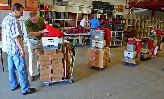 Doug Conlon, elections clerk for the San Sebastian Church precinct, watches as John Wilder, director of training for the Supervisor of Elections, shows him election materials for his precinct at the supervisor's office in St. Augustine on Monday, November 5, 2012. By PETER WILLOTT, peter.willott@staugustine.com