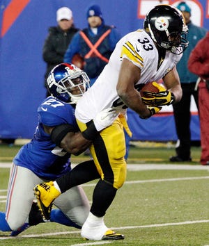 Pittsburgh running back Isaac Redman (33) is tackled by New York Giants safety Stevie Brown on Sunday.