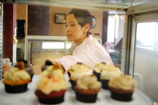 Helena Shih fills pastry cases at U Knead Sweets.