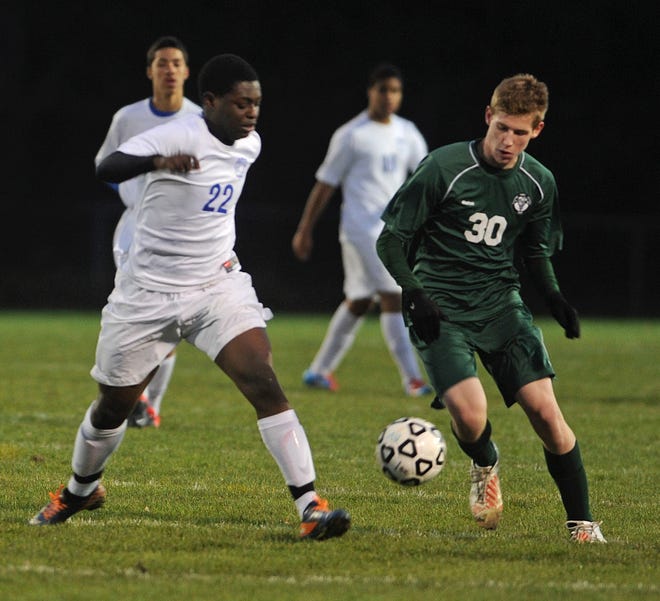 Canton High School's Sam Larson and Southeastern Regional's Jeffrey Pierre race for the ball during the boys soccer game in Easton on Monday, November 5, 2012.