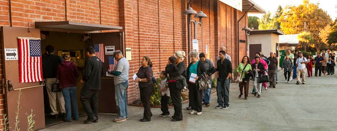 Early voters wait in line to vote Tuesday in the Sun Valley section of Los Angeles.