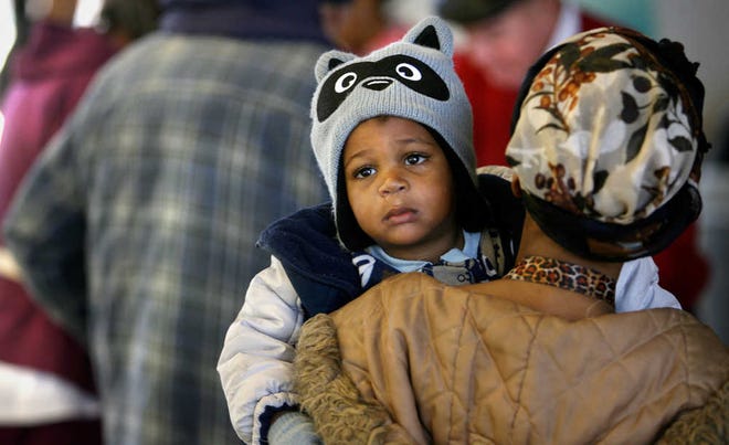 While the lines at Heritage Hall on Tuesday weren't long, they were long enough to make Emir Wynne tear up while being held by his mother, Jeveny Johnson.