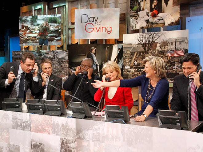 This image released by American Broadcasting Companies shows, from left, ABC News' Chris Cuomo, actor Tony Danza, actor Andre Braugher, Barbara Walters, Cynthia McFadden and David Novarro manning phones to take donations for victims of Hurricane Sandy during "Good Morning America," Monday, Nov. 5, 2012 in New York. Walters made a contribution of $250,000 to the American Red Cross and GMA co-host George Stephanopoulos followed suit with a donation for $50,000. (AP Photo/American Broadcasting Companies, Lou Rocco)