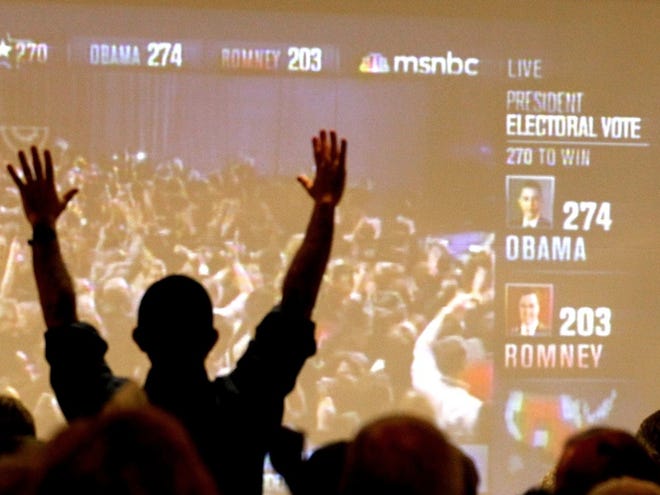 Arizona Democrats celebrate as President Barack Obama is declared the winner of the presidential race at Democratic Party gathering, Tuesday, Nov. 6, 2012, in Tucson, Ariz.