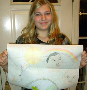 Pleasant Valley Middle School's Kaitlyn Bentley displays her winning "Peace Poster."