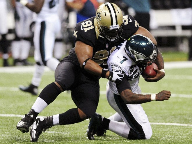 Philadelphia Eagles quarterback Michael Vick (7) is tackled by New Orleans Saints defensive end Will Smith (91) during their NFL football game, Monday, Nov. 5, 2012, in New Orleans. (AP Photo/The Lafayette Daily Advertiser, Paul Kieu) NO SALES