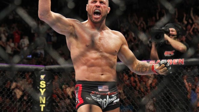 Randy Couture celebrates his win against James Toney during their UFC fight at the TD Garden on Saturday, August 28, 2010 in Boston, MA. Couture won via first round triangle choke. (AP Photo/Gregory Payan)