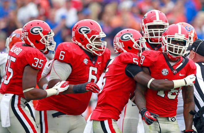 John Raoux/The Associated PressGeorgia safety Bacarri Rambo, far right, is mobbed by teammates after intercepting a pass during the the Bulldogs' victory over Florida on Oct. 27 in Jacksonville, Fla.