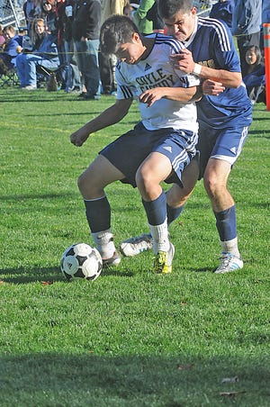 Coyle-Cassidy defender Chris Fong holds off a Archbishop Williams player in Sunday's victory at Hopewell Park. The Warriors were eliminated from tournament play with a loss to Nantucket Tuesday.