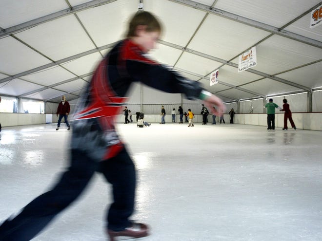 In this Dec. 24, 2005 file photo, skaters enjoy the ice-skating rink in Gainesville's Downtown Plaza. An ice rink is returning to downtown but through a different company.