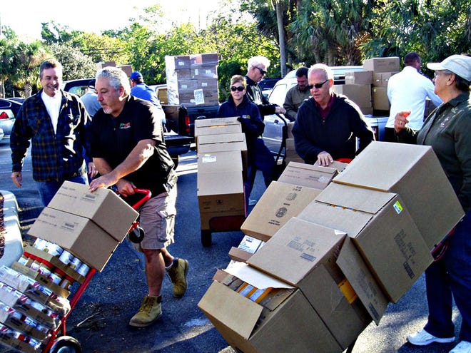 Community volunteers unload food for the Port Orange Pantry at Grace Episcopal Church.