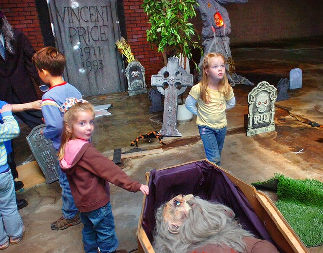 Isabella Canelli and Audrey Sterling check out the graveyard that has been set up in the Haunted House in Braintree. The annual PTO fundraiser will be held Thursday through Saturday.