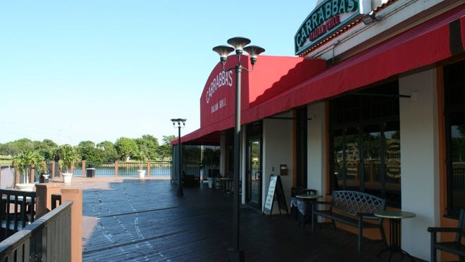 Located in the Wharfside at Boca Pointe shopping center, Carrabbas Italian Grill has an outside patio on the wooden deck overlooking a small lake.