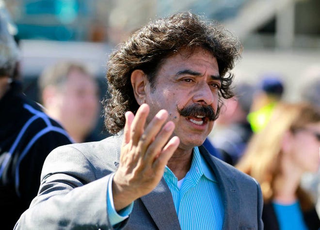 Jacksonville Jaguars team owner Shahid Khan talks with fans before an NFL football game against the Detroit Lions on Sunday.