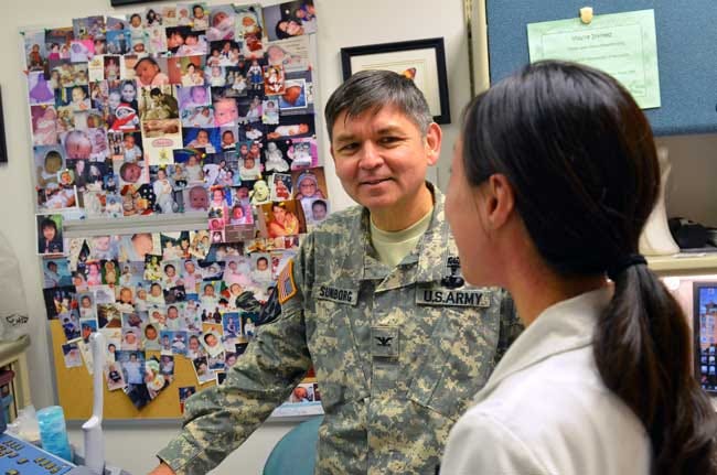 Col. (Dr.) Michael J. Sundborg, chief, gynecological oncology, Womack Army Medical Center, speaks with Navy Lt. (Dr.) Mae Wu, a third year obstetrics and gynecology resident from Walter Reed National Military Medical Center, during a mentorship moment in an exam room, Oct. 29.