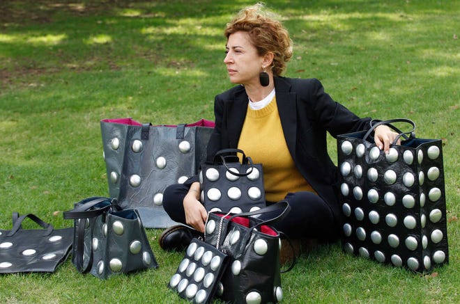 Ilaria Venturini Fendi, a member of the famous fashion family, displays bags from her Carmina Campus fashion project that produces bags from repurposed materials. The bags shown are made from garbage bags and soda cans.