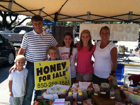 Family and friends of Destin beekeeper Ken Holman of Bone Brow Honey, sold their stock at the Community Center yard sale. Pictured from left, 6-year-old Jacob Stepp, Scott McKinney, 9-year-old Nathan Stepp, 13-year-old Grace Hardiman, 13-year-old Elizabeth Stepp and Robin Holman.
