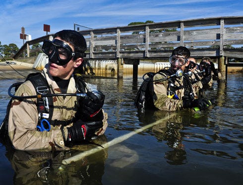 A U.S. Air Force special tactics Airman from the Special Tactics Training Squadron performs a sweep of the Soundside Marina waters during a yearly volunteer marina clean up on Hurlburt Field, Nov. 4. The STTS Airmen accomplished a large amount of diving minutes, which is essential to gain the necessary qualifications to be a combat scuba diver, but also turned a routine training mission into the opportunity to give back to the community of Hurlburt Field.