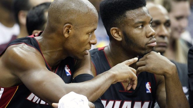 Miami Heat's Ray Allen, left, and Norris Cole talk on the bench during the first half of an NBA preseason basketball game against the Washington Wizards, Wednesday, Oct. 24, 2012, in Kansas City, Mo. (AP Photo/Colin E Braley)
