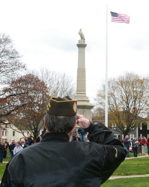 Honor Guard 1822 Post Commander Owen Hyams salutes the American Flag paying tribute to veterans.