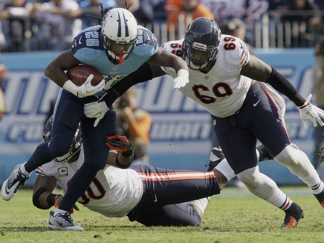 Tennessee Titans running back Chris Johnson (28) is stopped by Chicago Bears defensive tackle Henry Melton (69) and defensive end Julius Peppers (90) during the Nov. 4 game in Nashville, Tenn.