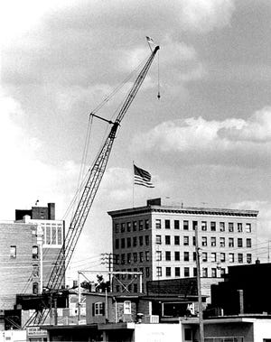 The flag on top of the crane in the foreground (near the corner of Federal and First streets NW) provides perspective for the flag atop The Lincoln Professional Building as it appeared several decades ago.