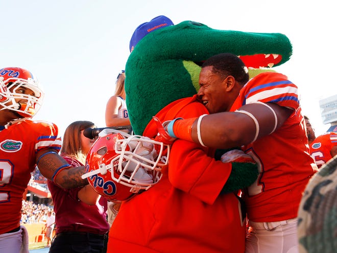 Florida's Mark Herndon hugs Florida mascot Albert after the team's 27-20 come from behind win against Louisiana in Gainesville Saturday, November 10, 2012. (Doug Finger/Staff Photographer)