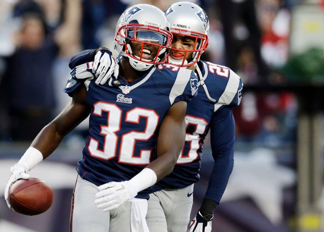 Patriots cornerback Devin McCourty (32) celebrates with safety Steve Gregory after he intercepted a pass in the end zone in the last minute of the Pats' 37-31 win over the Bills on Sunday in Foxboro.