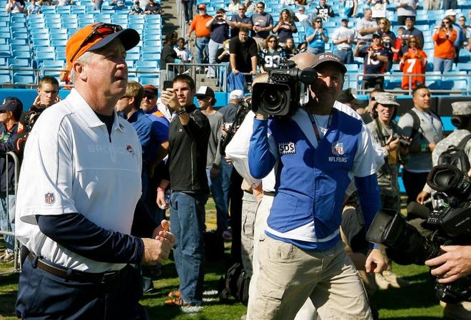 Denver coach and former Panther coach John Fox walks out on the field before Sunday's Panthers-Broncos game.