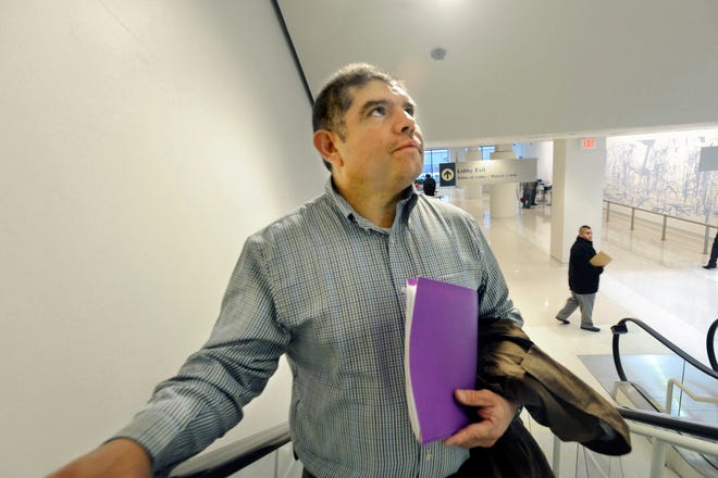 With review materials and documents in hand, Jose Montalvo glances up anxiously as he takes an elevator to United States Citizenship and Immigration Services offices on the third floor of 101 W. Congress Parkway in Chicago. Montalvo arrived at 8 a.m. after a 3-hour drive from his home in Princeville, where he works nine months each year at Seneca Foods Corp., for his final exam to gain U.S. citizenship.