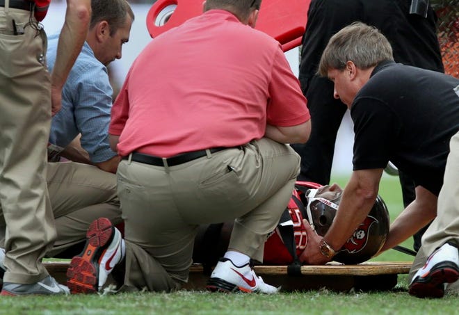 Tampa Bay linebacker Quincy Black is placed on a back board after injuring his neck.