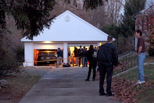 Authorities respond to a report of carbon monoxide poisoning on Harvest Lane in Toledo, Ohio, on Monday, Nov. 12, 2012. The bodies of three children and two adults were found inside the garage Monday, and authorities said they believe the deaths - apparently from carbon monoxide poisoning - weren't accidental. (AP Photo/The Blade, Amy E. Voigt)
