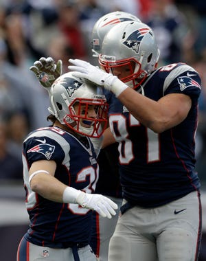 Patriots running back Danny Woodhead (39) is congratulated by teammate Rob Gronkowski after his touchdown during the first half of the Patriots' 37-31 victory over the Bills on Sunday in Foxboro.
