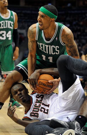 The Celtics' Courtney Lee (11) and the Bucks' Samuel Dalembert battle for a loose ball during the second half of the Celtics' victory on Saturday night in Milwaukee.