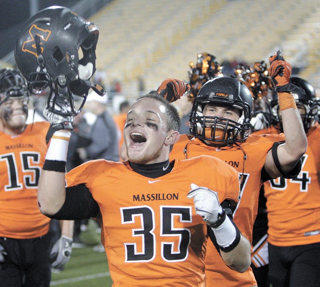 Massillon’s Ryan Rambo (35) and Dillon Cowan celebrate the 28-19 victory over McKinley in the Ohio High School Athletic Association Division I Region 2 semifinal at Dix Stadium in Kent on Saturday night.