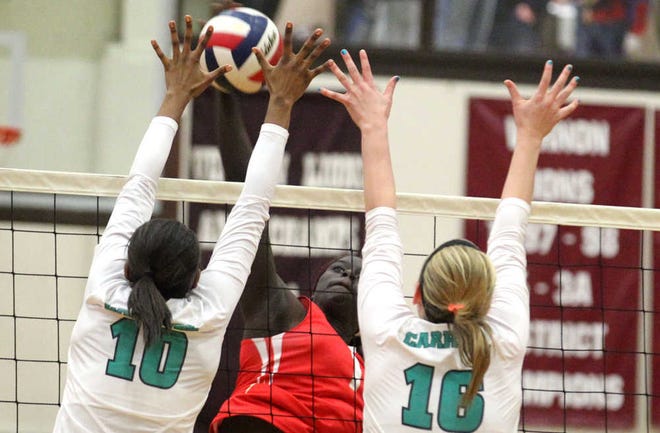 Lubbock Coronado's Lizzy Dimba has her shot blocked by Southlake Carroll's Maiya Burns and Taylor Gruenewald during their class 5A Region I regional quarter finals game on Tuesday in Vernon. (Stephen Spillman)