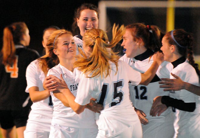 Franklin's Taylor Cogliano (left) celebrates with teammates after scoring a goal during the first half of the Panthers' 3-2 win over Oliver Ames in the Division 1 South final on Sunday evening.
