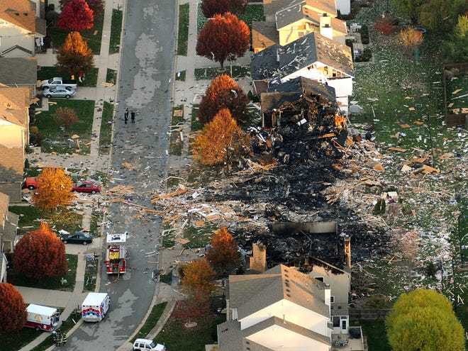 This aerial photo shows the two homes that were leveled and the numerous neighboring homes that were damaged from a massive explosion that sparked a huge fire and killed two people, Sunday, Nov. 11, 2012, in Indianapolis. Nearly three dozen homes were damaged or destroyed, and seven people were taken to a hospital with injuries, authorities said Sunday. The powerful nighttime blast shattered windows, crumpled walls and could be felt at least three miles away. (AP Photo/The Indianapolis Star, Matt Kryger)