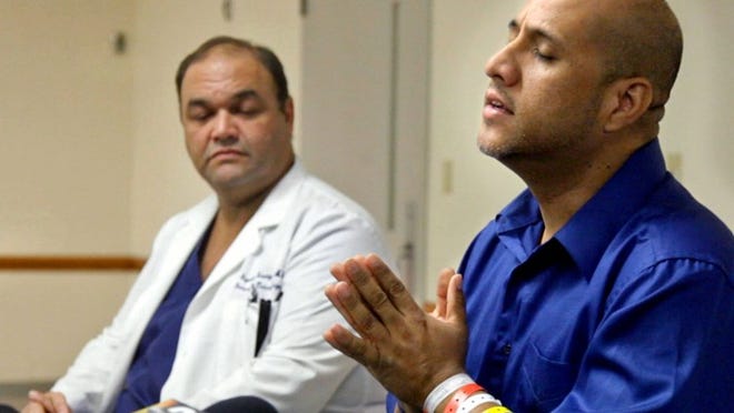 Angel Soto Jr. tells his story during a press conference at Delray Medical Center. At left is Dr. Gene Rodriguez, the trauma surgeon who treated Soto at Delray Medical Center. (Lannis Waters/The Palm Beach Post)