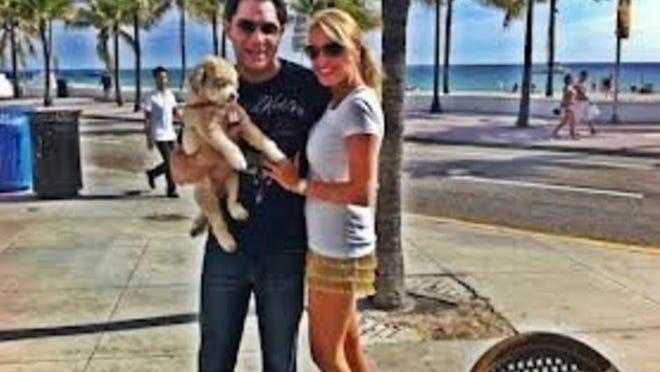 Former South Florida anchorman Joel Connable and his new wife, Angela, in Fort Lauderdale. Connable is holding his trained blood-sugar-sniffing dog, Lola, who was with him at all times — including when he died last week in his new home in Seattle after his insulin pump reportedly malfunctioned.