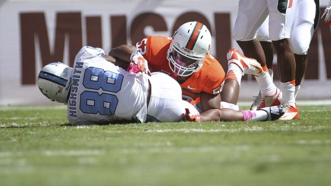 Miami's Denzel Perryman (52) tackles North Carolina's Erik Highsmith (88) during the first half of a NCAA college football game in Miami, Saturday, Oct. 13, 2012. (AP Photo/J Pat Carter)