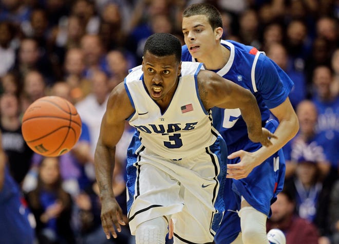 Duke's Tyler Thornton (3) and Georgia State's R.J. Hunter chase the ball during the second half of an NCAA college basketball game in Durham on Nov. 9.