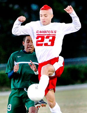 Jacksonville senior midfielder Austin Patselas (23) gains possession of the ball during the Cardinals’ 7-1 soccer win over West Brunswick in the second round of the NCHSAA 3-A playoffs.