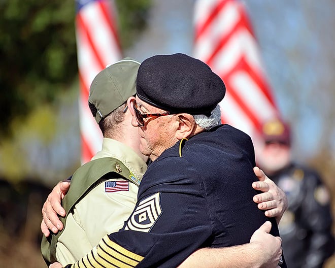 Bob Viner, retired 1st sergeant in the U.S. Army, hugs Marc Horton during the Dighton Veterans Cemetery Dedication on Monday, Nov. 12, 2012.