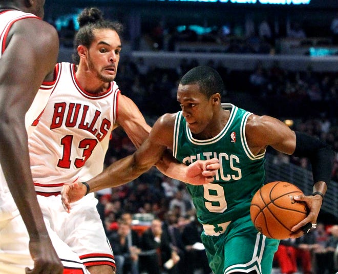 Boston Celtics guard Rajon Rondo drives on Chicago Bulls center Joakim Noah during the first half of Monday night's game in Chicago.