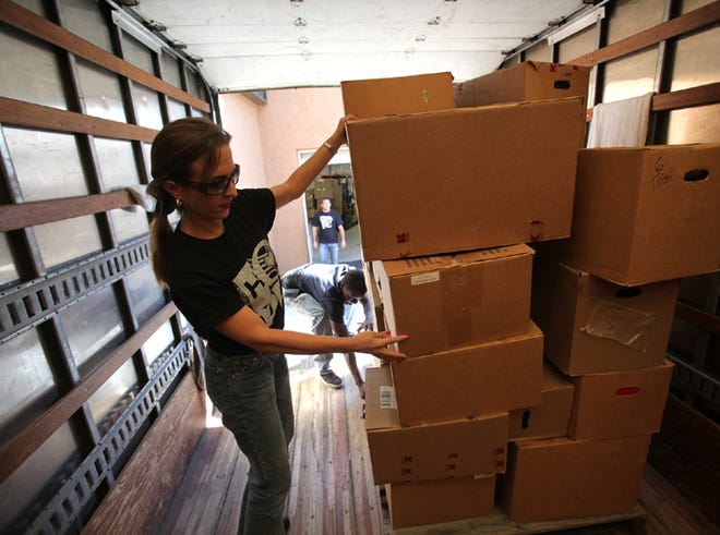 Sally Britton, president of Sponsors of Hope, helps unload a truck containing over 2,000 toiletry items and 1,300 clothing and toys Tuesday at the St. Andrews Baptist Church Center of Hope.
