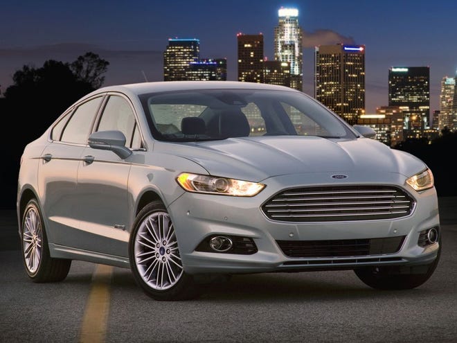 The Ford Fusion Hybrid has been reinvented for 2013, with elegant stylings and new safety features. (The Associated Press)